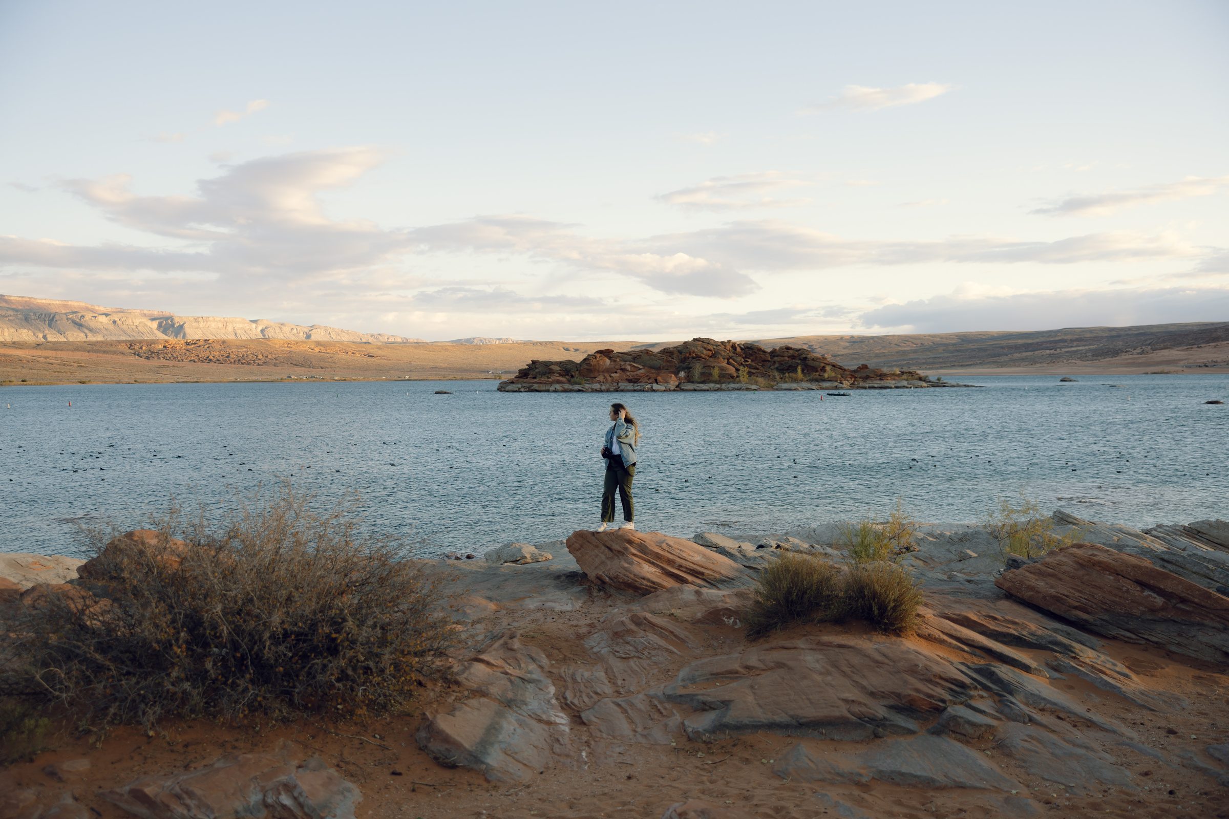 Sydney on location near the water, camera in hand