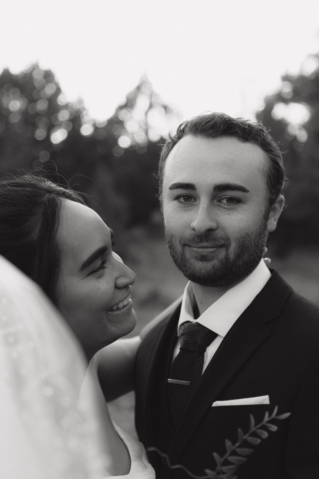Candid black and white moment between groom and bride