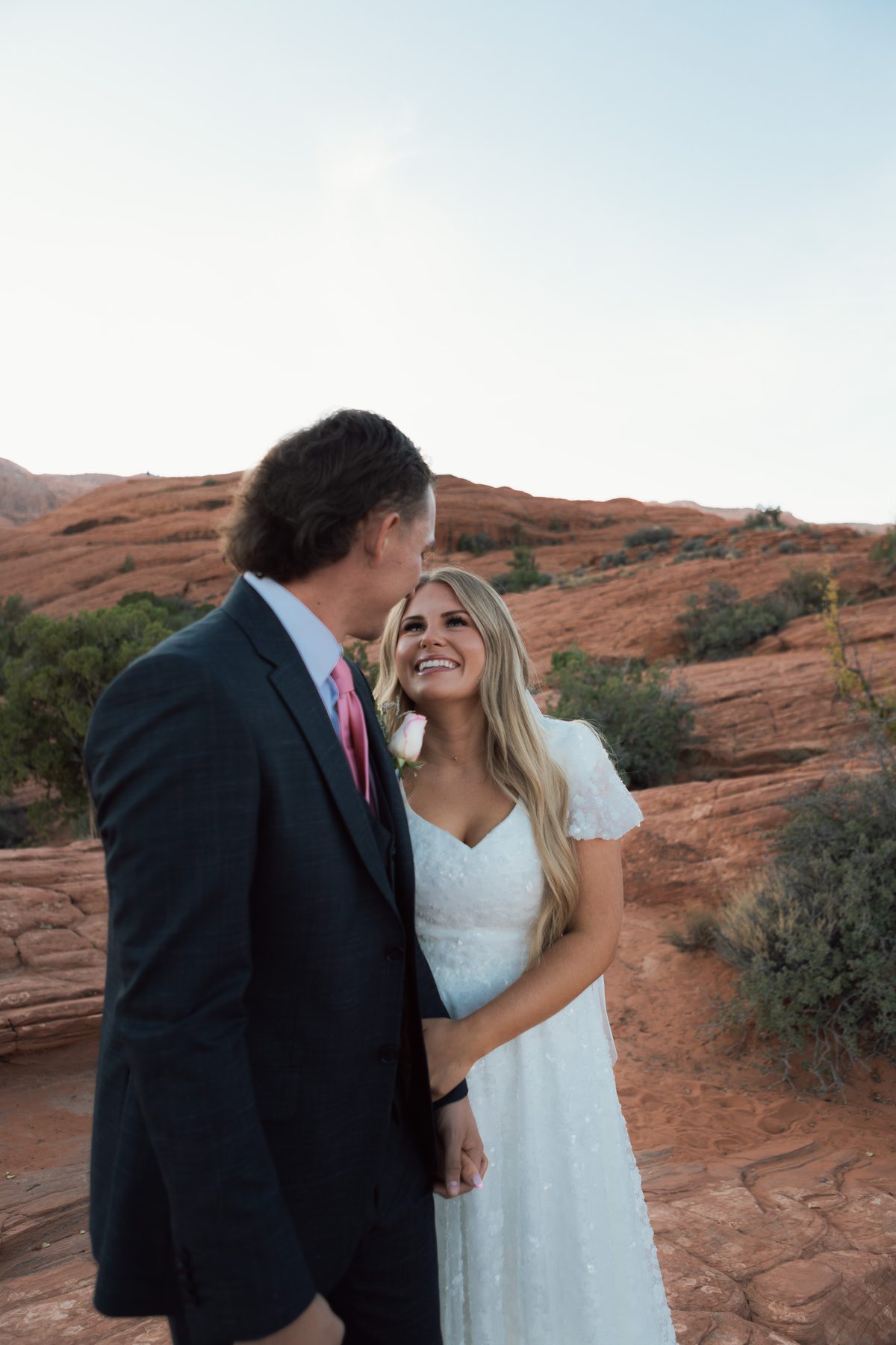 Bride and groom formal portrait against red rock